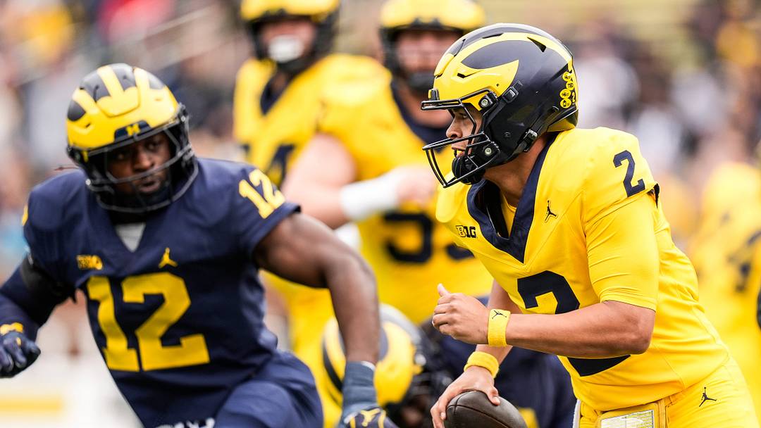 Team Maize quarterback Jadyn Davis (2) runs against Team Blue linebacker Nathaniel Owusu-Boateng (12) during the first half of the spring game at Michigan Stadium in Ann Arbor on Saturday, April 19, 2025. Team Maize quarterback Jadyn Davis (2) runs against Team Blue linebacker Nathaniel Owusu-Boateng (12) during the first half of the spring game at Michigan Stadium in Ann Arbor on Saturday, April 19, 2025.