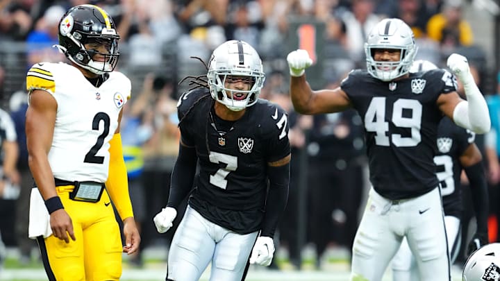Oct 13, 2024; Paradise, Nevada, USA; Las Vegas Raiders safety Tre'von Moehrig (7) celebrates between Pittsburgh Steelers quarterback Justin Fields (2) and Las Vegas Raiders defensive end Charles Snowden (49) after making a defensive play against the Pittsburgh Steelers during the first quarter at Allegiant Stadium.