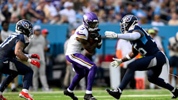 Nov 17, 2024; Nashville, Tennessee, USA;  Minnesota Vikings cornerback Stephon Gilmore (2) makes a catch between Tennessee Titans safety Amani Hooker (37) and linebacker Kenneth Murray Jr. (56) during the first half at Nissan Stadium. Mandatory Credit: Steve Roberts-Imagn Images