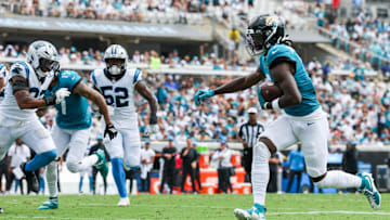 Sep 7, 2025; Jacksonville, Florida, USA; Jacksonville Jaguars wide receiver Brian Thomas Jr. (7) carries the ball for a 9-yard touchdown against the Carolina Panthers during the first half at EverBank Stadium. Mandatory Credit: Nathan Ray Seebeck-Imagn Images