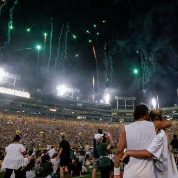 Green Bay Packers quarterback Jordan Love and his fiancée, Ronika Stone, watch a fireworks show at Family Night.