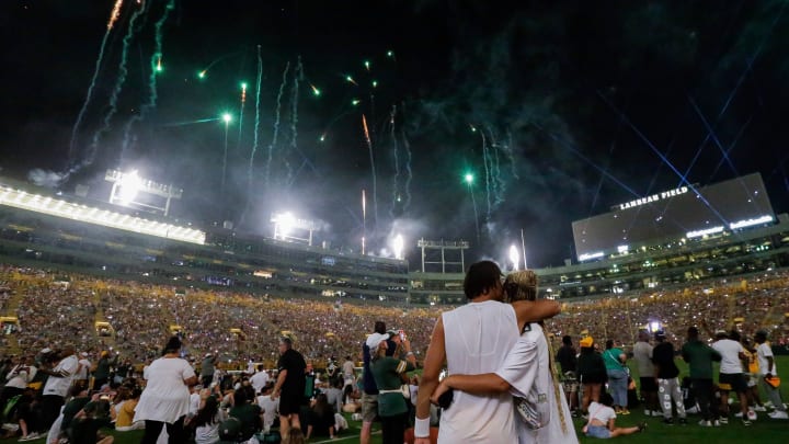 Green Bay Packers quarterback Jordan Love and his fiancée, Ronika Stone, watch a fireworks show at Family Night.