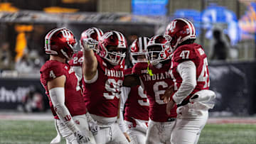 Nov 30, 2024; Bloomington, Indiana, USA; Indiana Hoosiers defensive lineman James Carpenter (99) celebrates his run for a first down with teammates  in the second half against the Purdue Boilermakers at Memorial Stadium. Mandatory Credit: Trevor Ruszkowski-Imagn Images
