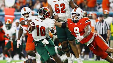 Sep 7, 2024; Miami Gardens, Florida, USA; Florida A&M Rattlers quarterback Daniel Richardson (10) is sacked by Miami Hurricanes defensive lineman Tyler Baron (9) during the third quarter at Hard Rock Stadium. Mandatory Credit: Sam Navarro-Imagn Images