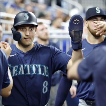 Seattle Mariners Dominic Canzone (8) celebrates scoring against the Miami Marlins in the eighth inning at loanDepot Park on June 22.