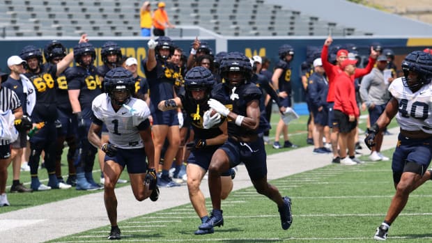 West Virignia University receiver Traylon Ray running down the sidelines during fall camp. 