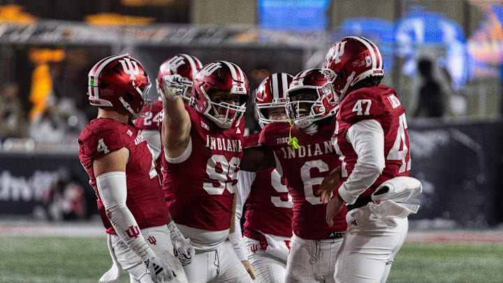 Nov 30, 2024; Bloomington, Indiana, USA; Indiana Hoosiers defensive lineman James Carpenter (99) celebrates his run for a first down with teammates  in the second half against the Purdue Boilermakers at Memorial Stadium. Mandatory Credit: Trevor Ruszkowski-Imagn Images