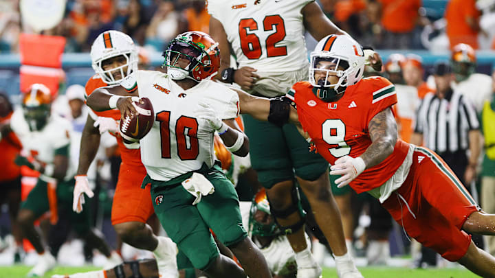 Sep 7, 2024; Miami Gardens, Florida, USA; Florida A&M Rattlers quarterback Daniel Richardson (10) is sacked by Miami Hurricanes defensive lineman Tyler Baron (9) during the third quarter at Hard Rock Stadium. Mandatory Credit: Sam Navarro-Imagn Images