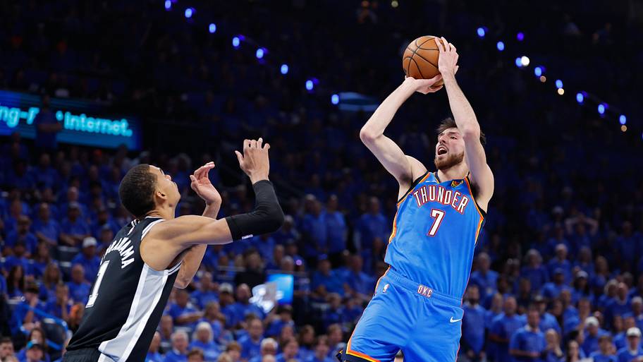 Oklahoma City Thunder center Chet Holmgren shoots the ball while defended by San Antonio Spurs center Victor Wembanyama.
