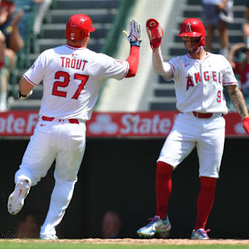 Jun 11, 2025; Anaheim, California, USA; Los Angeles Angels designated hitter Mike Trout (27) is greeted by shortstop Zach Neto (9) after scoring a run against the Athletics during the sixth inning at Angel Stadium. Mandatory Credit: Gary A. Vasquez-Imagn Images
