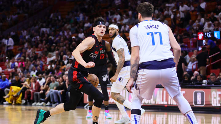 Apr 10, 2024; Miami, Florida, USA; Miami Heat guard Tyler Herro (14) drives to the basket as Dallas