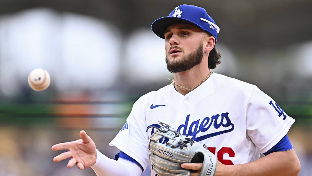 Apr 12, 2026; Los Angeles, California, USA; Los Angeles Dodgers second baseman Alex Freeland (76) tosses the ball to first base to force an out against the Texas Rangers during the fifth inning at Dodger Stadium. Mandatory Credit: Jonathan Hui-Imagn Images