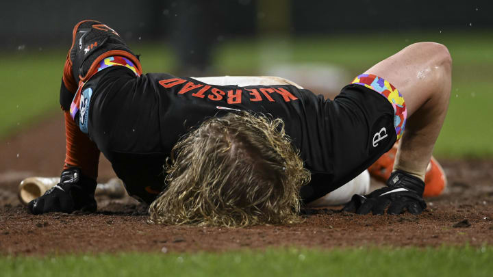 Jul 12, 2024; Baltimore, Maryland, USA;  Baltimore Orioles outfielder Heston Kjerstad (13) lays on the ground after being hit by a pitch in the head during the ninth inning against the New York Yankees at Oriole Park at Camden Yards