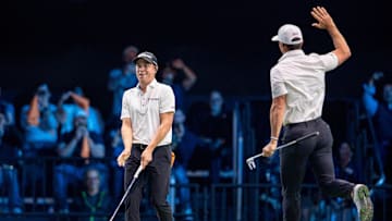 Justin Thomas of Atlanta Drive GC reacts, left, to making a putt as teammate Billy Horschel comes around for a high five during a TGL match at the SoFi Center on January 21, 2025, in Palm Beach Gardens, Florida.