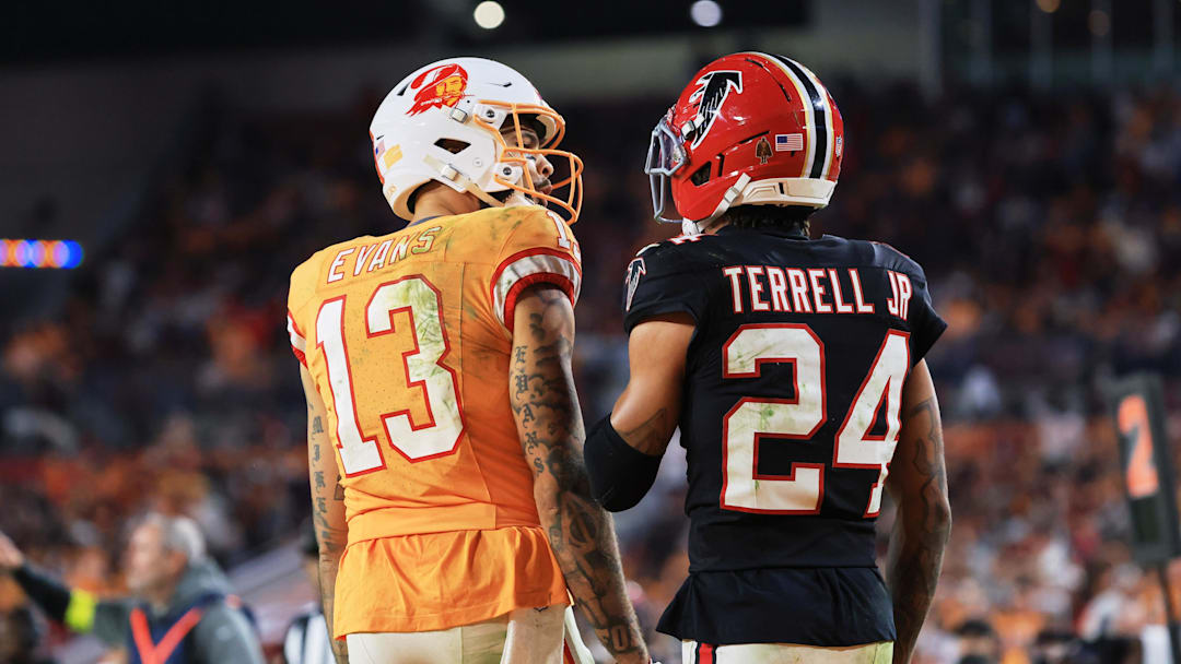 Dec 11, 2025; Tampa, Florida, USA; Tampa Bay Buccaneers wide receiver Mike Evans (13) chats with Atlanta Falcons cornerback A.J. Terrell Jr. (24) between plays during the fourth quarter at Raymond James Stadium. Mandatory Credit: Kim Klement Neitzel-Imagn Images