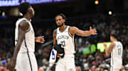 Nov 16, 2025; Washington, District of Columbia, USA;  Brooklyn Nets center Nic Claxton (33) celebrates with guard Drake Powell (4) during a time out against the Washington Wizards during the fourth quarter at Capital One Arena. Mandatory Credit: Rafael Suanes-Imagn Images