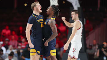 Nov 28, 2024; Paradise Island, Bahamas, BHS;  West Virginia Mountaineers guard Javon Small (7) celebrates with West Virginia Mountaineers guard Tucker DeVries (12) after scoring during the second half against the Louisville Cardinals at Imperial Arena at the Atlantis resort.  Mandatory Credit: Kevin Jairaj-Imagn Images
