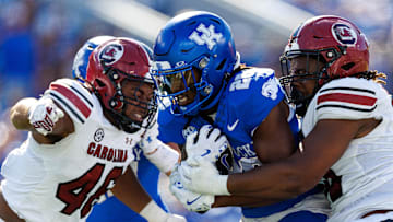 Sep 7, 2024; Lexington, Kentucky, USA; Kentucky Wildcats running back Jason Patterson (26) runs the ball through South Carolina Gamecocks defenders during the second quarter at Kroger Field. Mandatory Credit: Jordan Prather-Imagn Images