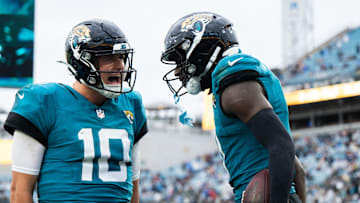Dec 29, 2024; Jacksonville, Florida, USA; Jacksonville Jaguars wide receiver Brian Thomas Jr (7) and quarterback Mac Jones (10) celebrate a touchdown against the Tennessee Titans in the fourth quarter at EverBank Stadium. 