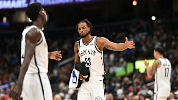 Nov 16, 2025; Washington, District of Columbia, USA;  Brooklyn Nets center Nic Claxton (33) celebrates with guard Drake Powell (4) during a time out against the Washington Wizards during the fourth quarter at Capital One Arena. Mandatory Credit: Rafael Suanes-Imagn Images