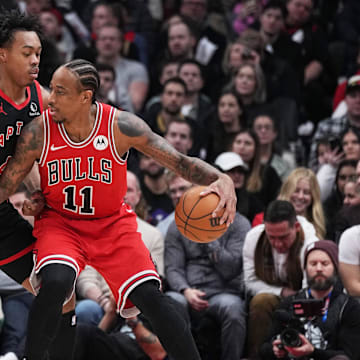 Jan 18, 2024; Toronto, Ontario, CAN; Chicago Bulls forward DeMar DeRozan (11) controls the ball as Toronto Raptors forward Scottie Barnes (4) tries to defend during the second quarter at Scotiabank Arena. Mandatory Credit: Nick Turchiaro-Imagn Images