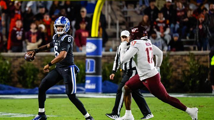 Nov 23, 2024; Durham, North Carolina, USA; Duke Blue Devils quarterback Maalik Murphy (6) runs with the football against Virginia Tech Hokies defensive lineman Cole Nelson (17) during the first half of the game at Wallace Wade Stadium. Mandatory Credit: Jaylynn Nash-Imagn Images
