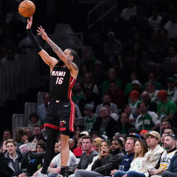 Apr 24, 2024; Boston, Massachusetts, USA; Miami Heat forward Caleb Martin (16) shoots for three points against Boston Celtics forward Sam Hauser (30) in the second quarter during game two of the first round for the 2024 NBA playoffs at TD Garden. Mandatory Credit: David Butler II-USA TODAY Sports