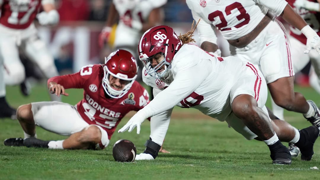 Alabama Crimson Tide defensive lineman Tim Keenan III (96) recovers the ball after blocking the punt of Oklahoma Sooners kicker Grayson Miller (43) during a first-round College Football Playoff game between the University of Oklahoma Sooners (OU) and the Alabama Crimson Tide at Gaylord Family Ð Oklahoma Memorial Stadium in Norman, Okla., Friday, Dec. 19, 2025.