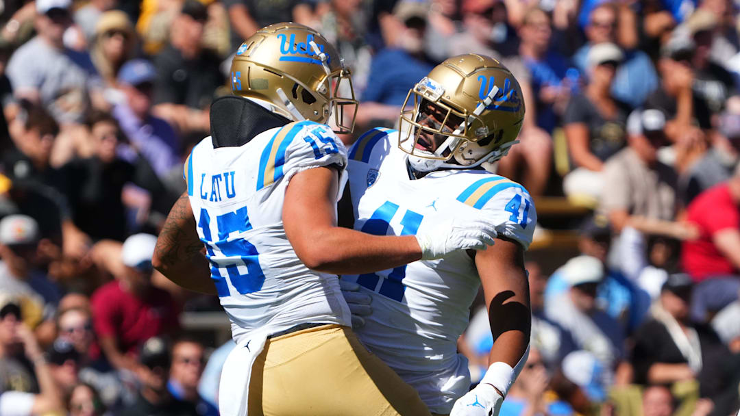 Sep 24, 2022; Boulder, Colorado, USA; UCLA Bruins linebacker Laiatu Latu (15) and linebacker Devin Aupiu (41) celebrate a play in the first quarter against the Colorado Buffaloes at Folsom Field. Mandatory Credit: Ron Chenoy-Imagn Images