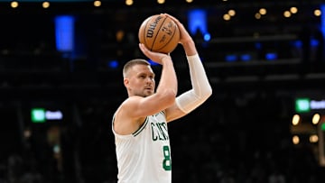 Apr 11, 2025; Boston, Massachusetts, USA; Boston Celtics center Kristaps Porzingis (8) shoots the ball against the Charlotte Hornets during the first half at TD Garden. Mandatory Credit: Eric Canha-Imagn Images
