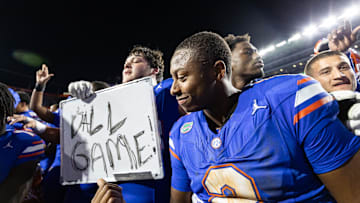 Nov 16, 2024; Gainesville, Florida, USA; Florida Gators quarterback DJ Lagway (2) gestures towards a sign held by Florida Gators offensive lineman Austin Barber (58) after a game against the LSU Tigers at Ben Hill Griffin Stadium. Mandatory Credit: Matt Pendleton-Imagn Images