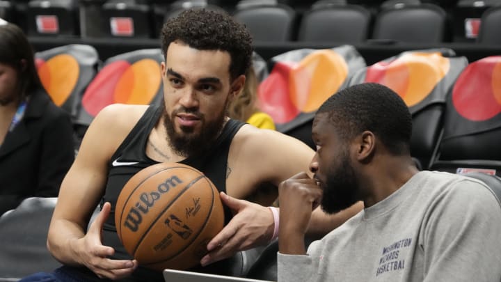 Apr 7, 2024; Toronto, Ontario, CAN; Washington Wizards guard Tyus Jones (left) talks with a coach before a game against the Toronto Raptors at Scotiabank Arena. Mandatory Credit: John E. Sokolowski-USA TODAY Sports