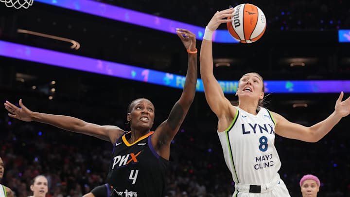 Phoenix Mercury forward Natasha Mack (4) fights for a rebound with Minnesota Lynx forward Alanna Smith (8) during their WNBA semifinal playoff game at PHX Arena on Sept. 28, 2025.
