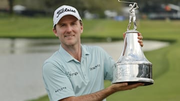 Mar 9, 2025; Orlando, Florida, USA;  Russell Henley holds the champions trophy after winning the Arnold Palmer Invitational golf tournament at Bay Hill.