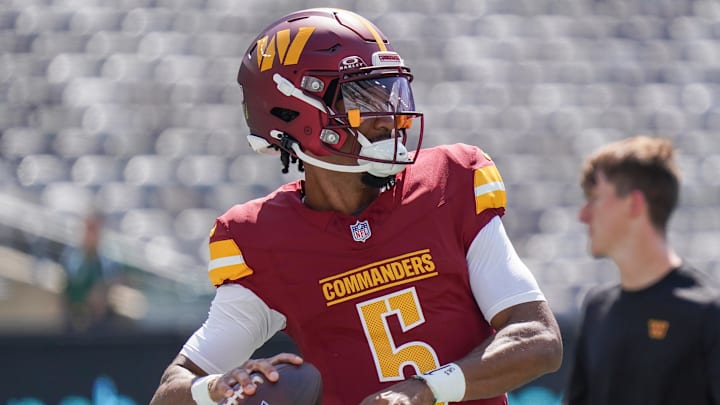 Aug 10, 2024; East Rutherford, New Jersey, USA; Washington Commanders quarterback Jayden Daniels (5) warms up before the game against the New York Jets at MetLife Stadium. Mandatory Credit: Lucas Boland-Imagn Images