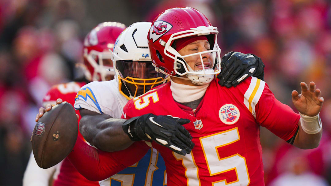 Dec 14, 2025; Kansas City, Missouri, USA; Los Angeles Chargers linebacker Odafe Oweh (98) sacks Kansas City Chiefs quarterback Patrick Mahomes (15) during the second half at GEHA Field at Arrowhead Stadium. Mandatory Credit: Jay Biggerstaff-Imagn Images