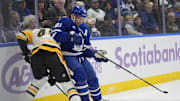 Nov 3, 2025; Toronto, Ontario, CAN; Toronto Maple Leafs forward John Tavares (91) battles with Pittsburgh Penguins defenseman Harrison Brunicke (45) during the first period at Scotiabank Arena. Mandatory Credit: John E. Sokolowski-Imagn Images