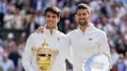 Carlos Alcaraz of Spain and Novak Djokovic of Serbia pose with their trophies.