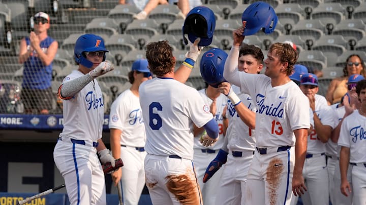 May 20, 2025; Hoover, AL, USA; Florida shortstop Bobby Boser (6) is congratulated at the plate after hitting a homer against South Carolina in the first round of the SEC Baseball Tournament at the Hoover Met.