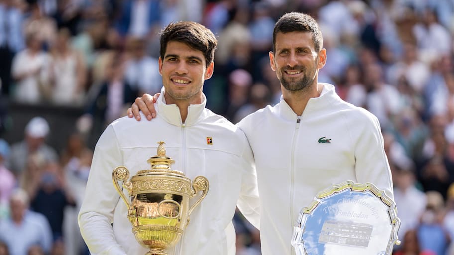 Carlos Alcaraz of Spain and Novak Djokovic of Serbia pose with their trophies. | Susan Mullane-Imagn Images