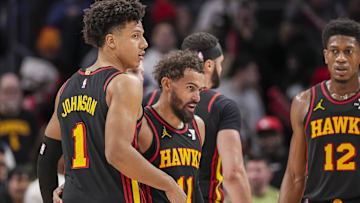 Dec 28, 2024; Atlanta, Georgia, USA; Atlanta Hawks guard Trae Young (11) reacts with forward Jalen Johnson (1) after the Hawks defeated the Miami Heat at State Farm Arena. Mandatory Credit: Dale Zanine-Imagn Images