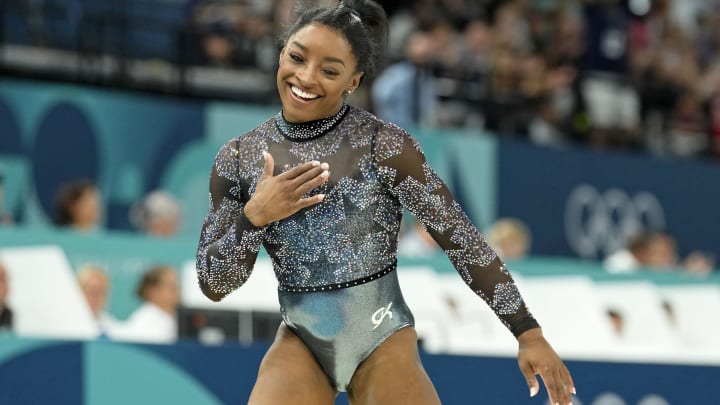 Jul 28, 2024; Paris, France; Simone Biles of the United States reacts after performing on the beam in womenís qualification during the Paris 2024 Olympic Summer Games at Bercy Arena. 