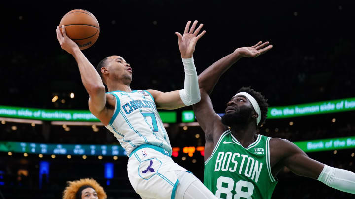 Apr 12, 2024; Boston, Massachusetts, USA; Boston Celtics center Neemias Queta (88) defends against Charlotte Hornets guard Bryce McGowens (7) in the second half at TD Garden.