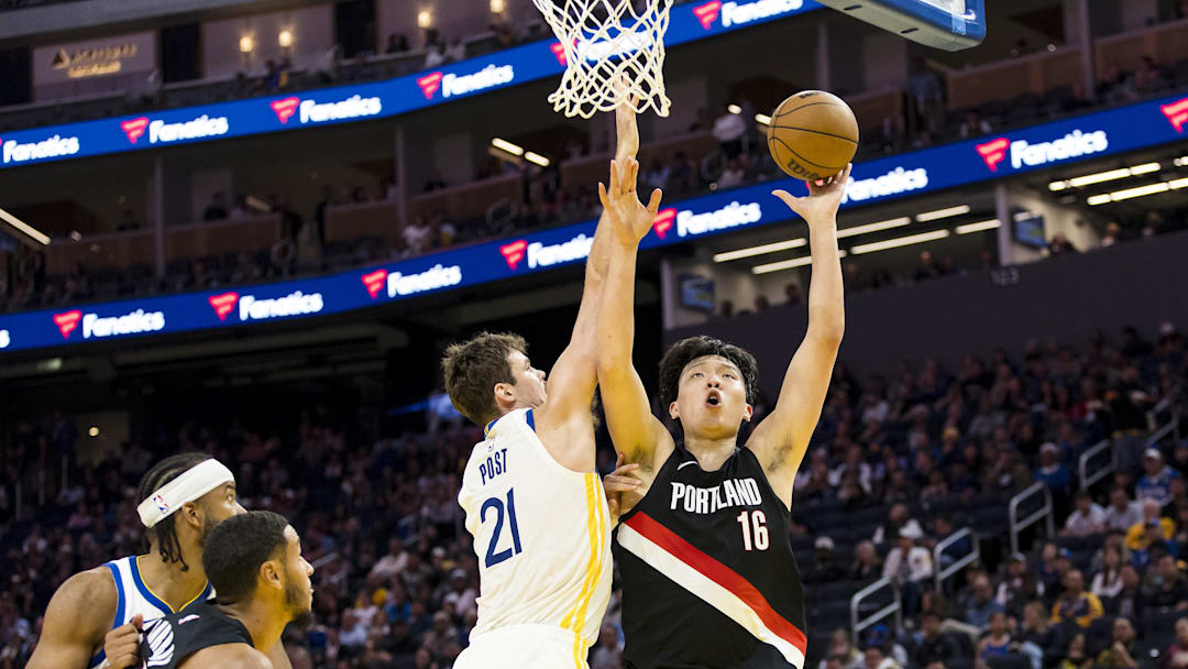 Oct 8, 2025; San Francisco, California, USA;  Portland Trail Blazers center Yang Hansen (16) shoots as Golden State Warriors center Quinten Post (21) defends during the second quarter at Chase Center. Mandatory Credit: John Hefti-Imagn Images