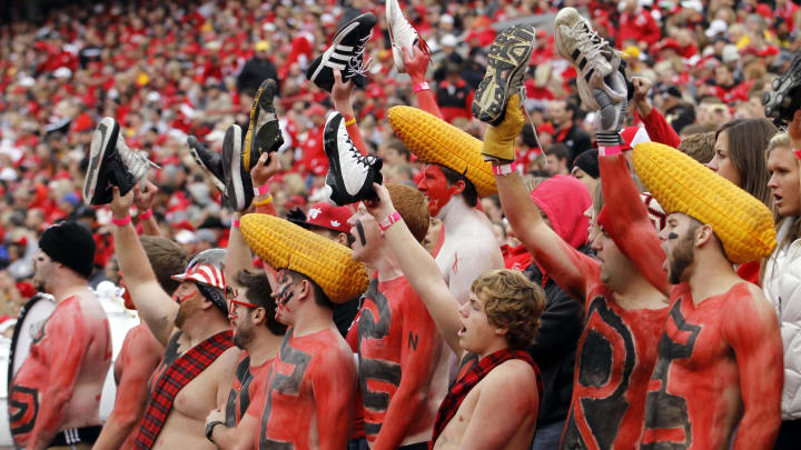 Nebraska Cornhuskers fans hold their shoes up 