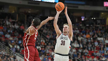 Mar 21, 2025; Raleigh, NC, USA;  Oklahoma Sooners forward Mohamed Wague (5) defends against Connecticut Huskies forward Liam McNeeley (30) during the first half at Lenovo Center. Mandatory Credit: Zachary Taft-Imagn Images