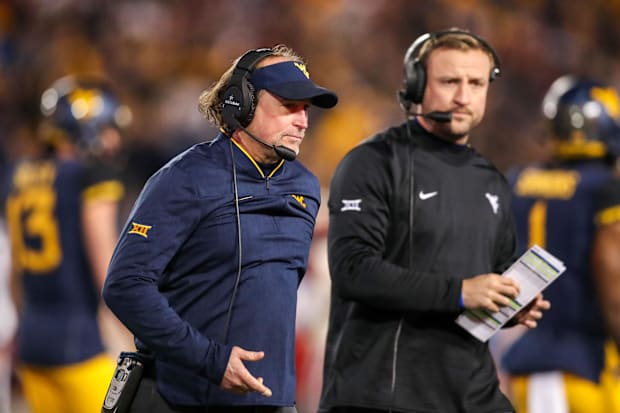  Dana Holgorsen walks off the field  at Milan Puskar Stadium.