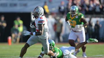 Jan 1, 2025; Pasadena, CA, USA; Ohio State Buckeyes wide receiver Emeka Egbuka (2) runs against Oregon Ducks defensive back Kobe Savage (5) in the first quarter in the 2025 Rose Bowl college football quarterfinal game at Rose Bowl Stadium. Mandatory Credit: Jayne Kamin-Oncea-Imagn Images