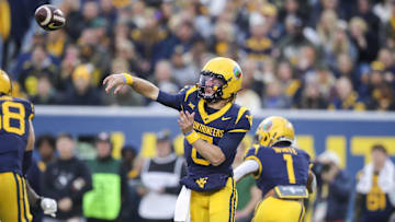 Nov 16, 2024; Morgantown, West Virginia, USA; West Virginia Mountaineers quarterback Garrett Greene (6) throws a pass during the first quarter against the Baylor Bears at Mountaineer Field at Milan Puskar Stadium. Mandatory Credit: Ben Queen-Imagn Images