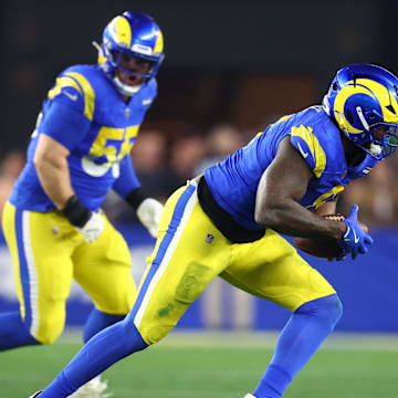 Jan 13, 2025; Glendale, AZ, USA; Los Angeles Rams linebacker Jared Verse (8) recovers a fumble against the Minnesota Vikings during the first half in an NFC wild card game at State Farm Stadium. Mandatory Credit: Mark J. Rebilas-Imagn Images